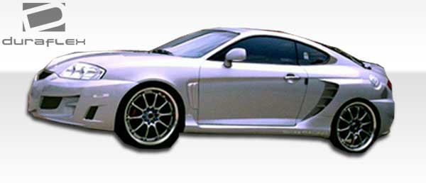 2003-2006 Hyundai Tiburon Duraflex SC-5 Body Kit - 6 Piece - Includes SC-5 Front Bumper Cover (100447) SC-5 Rear Bumper Cover (100448) SC-5 Side Skirts Rocker Panels (100450) SC-5 Rear Fender Flares (100449)